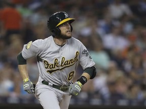 Oakland Athletics' Jed Lowrie watches his solo home run during the fifth inning against the Detroit Tigers in a baseball game Tuesday, June 26, 2018, in Detroit.