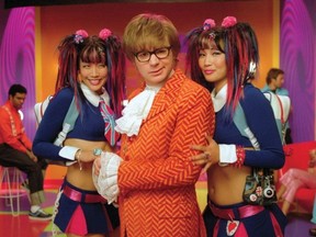 Mike Myers as Austin Powers, flanked by Fook Mi (Diane Mizota, left) and Fook Yu (Carrie Ann Inaba) in the movie, Austin Powers In Goldmember.