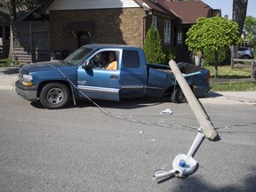 Power lines stretched across two cars involved in a collision at the intersection of Hanna and Goyeau streets on June 8, 2018, forcing those inside to wait until the power was cut.