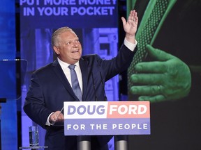 Ontario PC leader Doug Ford looks up while giving a tribute to his late brother Rob as he reacts after winning the Ontario Provincial election to become the new premier in Toronto on June 7, 2018.