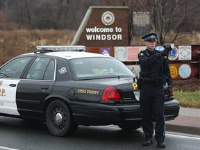 An OPP officer checks for speeders on Huron Church Road in Windsor in this November 2010 file photo.