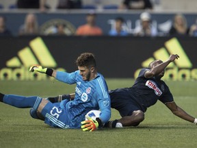 Toronto FC's Alex Bono, left, makes the save on the shot by Philadelphia Union's Fafa Picault, right, during the first half of an MLS soccer match Friday, June 8, 2018, in Chester, Pa.