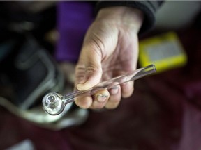 Melissa, a homeless woman found hanging out under the  overpass at University Avenue West between Caron Avenue and Salter Avenue holds a crystal meth pipe she pulled out of her bag, Wednesday, June 20, 2018.