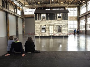 FILE - In this April 1, 2018 file photo, visitors view the rebuilt house of Rosa Parks at the WaterFire Arts Center in Providence, R.I. The house where Parks sought refuge in Detroit after fleeing the South will be auctioned after being turned into a work of art. Guernsey's auction house says the sale will be held mid-summer and that it's expected to fetch seven figures.