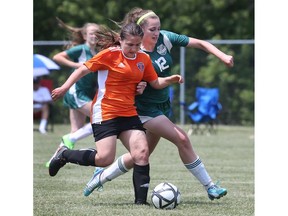 Anicka Quimby, left, of the Sandwich Sabres and Katie Connelly of the Holy Cross Hurricanes battle for the ball during their OFSAA matchup on June 8, 2018, in Windsor.