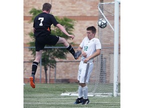 WINDSOR, ON. JUNE 7, 2018. --  Vlad Jidkov, left, of L'Essor Secondary School kicks the ball pass Bruce DeLuca of St. Catharines Holy Cross during their OFSSA soccer game in Windsor, ON. on Thursday, June 7, 2018.