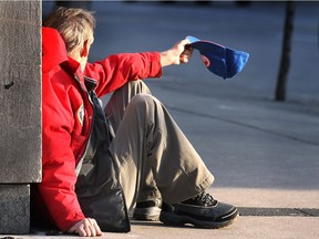 A man begs for money on Ouellette Avenue on Mar. 16, 2011.
