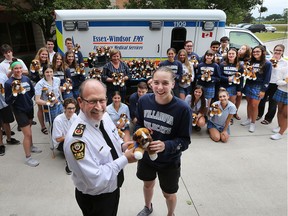 St. Thomas of Villanova Catholic Secondary School students made a cute and cuddly donation to the Essex-Windsor Emergency Medical Services on June 20, 2018. Grade 12 social justice students raised money and purchased 101 plush St. Bernards. The stuffed animals are handed out to children in crisis situations as a way of comforting them. Essex-Windsor EMS Chief Bruce Krauter poses with Villanova student Kristen Swiatoschik and her classmates during the event.