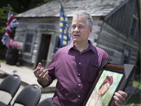 Tom Rindlisbacber, holds a new portrait of Chief Tecumseh, that he suggested his mother Eleanor paint, at at celebration of the 250th birthday of Chief Tecumseh, Saturday, June 23, 2018.