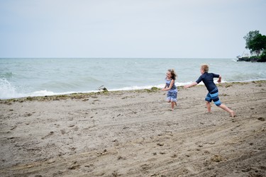 Kids have fun chasing each other on the sand of Colchester Beach.