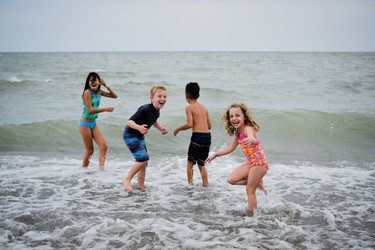 Kids frolic in the waves at Colchester Beach.