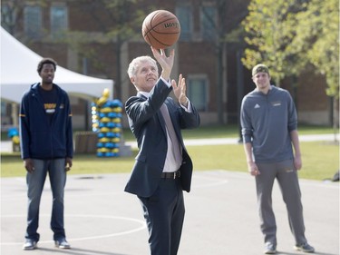 Alan Wildeman, University of Windsor president, shoots hoops with members of the Lancers Men's basketball team on the new basketball court at the David A. Wilson Commons Sept. 29, 2017.  The gathering place between the Odette Building and the Medical Education Building was formally inaugurated today.