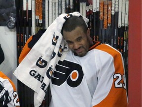 Philadelphia Flyers goalie Ray Emery wipes his head off after he was replaced by Steve Mason during the third period of an NHL hockey game against the Chicago Blackhawks Wednesday, Dec. 11, 2013, in Chicago. The Blackhawks won 7-2.