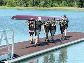 Members of the LaSalle Rowing Club carry a boat during the official opening of a new, floating dock at Front Road Park on July 7, 2018. The new dock replaces an aging dock. It was engineered by Poralu Marine and is made from aluminum and polyethylene eco-style decking.