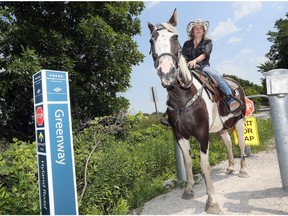 Tanya Harrison and her Tennessee Walker 'Southern' are shown July 10, 2018, at the Greenway Trail opening on Hyland Side Road.  Harrison has started a petition to allow more horseback riding on the local greenway trail system.