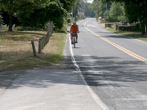 Cyclist Art Drake carefully rides along a portion of County Road 50 with no bike lane in Kingsville, Ontario on July 23, 2018.