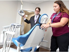 Ron Dunn, executive director of Downtown Mission is shown the dental chair by dental hygienist Erika Gossmann during a pre-grand opening of Alan Quesnel Community Dental Clinic at 875 Ouellette Avenue Tuesday July 24, 2018.