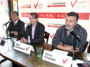 Mayoral candidate Matt Marchand is flanked by Unifor's Dino Chiodo, right, and businessman Nick Marentette, left, during a morning news conference at Downtown Pizza Company on July 26, 2018.
