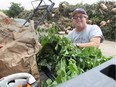 John Weber of Windsor unloads lawn clippings at Windsor's public drop-off depot off Central Avenue on July 30, 2018. Windsorites will soon be required to separate their food wastes from their regular garbage.
