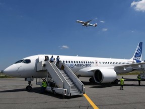 This photo taken on July 10, 2018 shows the new Airbus A220-300 parked on the tarmac on July 10, 2018 at the Airbus delivery center, in Colomiers southwestern France.