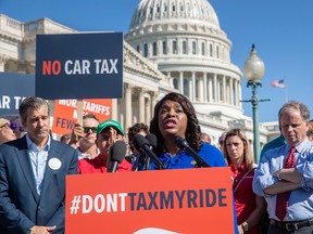 Rep. Terri Sewell, D-Ala., flanked by John Bozzella, president of Global Automakers, left, and Sen. Doug Jones, D-Ala., joins Americans who work for international auto companies to demonstrate against trade tariffs they say will negatively impact U.S. auto manufacturing, on Capitol Hill in Washington, Thursday.