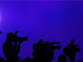 Media work at the Volkswagon press conference at the International Auto Show at Cobo Hall in Detroit on Jan. 13, 2014.