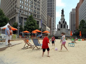 Children play in a temporary beach in Campus Martius during a Wheelhouse Detroit bike tour in Detroit on August 11, 2013.