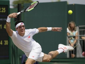 Milos Raonic of Canada returns a ball to Dennis Novak of Austria during their men's singles match on the sixth day at the Wimbledon Tennis Championships in London, July 7, 2018.