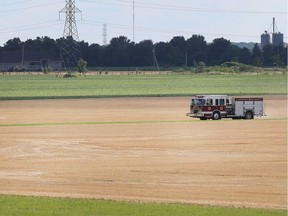 A Lakeshore Fire and Rescue truck is shown in a wheat field on July 17, 2018, after a crew put out a fire at a farm on Lakeshore Rd. 101 just south of Highway 401.