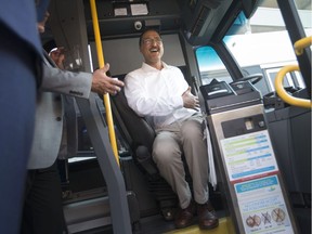 Infrastructure Minister Amarjeet Sohi gets behind the wheel as Mayor Drew Dilkens and Transit Windsor executive director Pat Delmore look on during a press event revealing 24 new Transit Windsor buses on July 16, 2018.