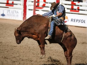 Marcos Gloria, of Edmonton, Alberta, wins the Bull Riding event during finals rodeo action at the Calgary Stampede in Calgary on July 15, 2018.