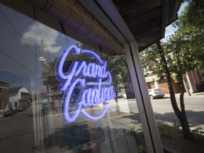 The Grand Cantina sign shines neon purple at the new Ford City restaurant, on July 12, 2018.