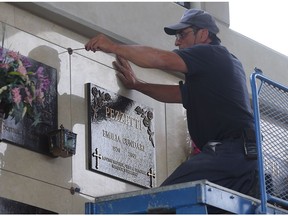 Forgotten no more. John Seguin, an employee at Heavenly Rest Cemetery in Windsor, installs a marker for Emilia Cundari, who was a famous soprano in the 1950s. Her crypt did not have a marker for decades.