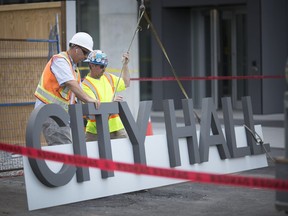 Finishing touches are made on July 19, 2018, as workers get ready to hoist a large 'Windsor City Hall' sign into position on the exterior of the new $34-million municipal building.