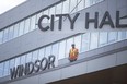 In this July 19, 2018, file photo, finishing touches were being made as workers installed a large 'Windsor City Hall' sign onto the new city hall. Most city hall operations will be closed on Monday.