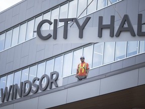 In this July 19, 2018, file photo, finishing touches were being made as workers installed a large 'Windsor City Hall' sign onto the new city hall. Most city hall operations will be closed on Monday.