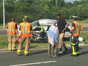 Bona Mohammed, 22, and some of his family members assess the wreckage of his mother¹s vehicle on July 5, 2018, after an oncoming vehicle crossed the Dougall Parkway median, hit the vehicle he was driving, causing it to flip over several times.