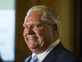 Ontario Premier Doug Ford speaks to media outside of his office at Queen's Park in Toronto on July 11, 2018. Ford announced the resignation of Hydro One CEO Mayo Schmidt.