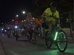 Cyclists with decked out bikes participate in the Friday Night Lights ride Friday July 13, 2018.