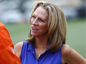 FILE - In this Saturday, July 29, 2017, file photo, broadcaster Beth Mowins chats with a reporter at the Denver Broncos NFL football training camp in Englewood, Colo. ESPN is going with a fresh approach for its first 2018 regular-season broadcast of "Monday Night Football." Two announcers with plenty of NFL credentials but far more entrenched in the college game these days will be handling the Jets-Lions game from Detroit: Beth Mowins and Brian Griese.