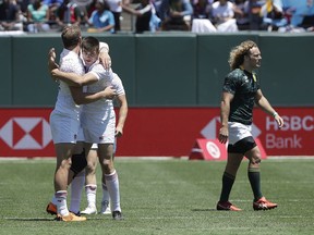 England's Harry Glover, left, celebrates with as South Africa's Werner Kok, right, walks away after a Rugby Sevens World Cup semifinal in San Francisco, Sunday, July 22, 2018. England won 29-7.