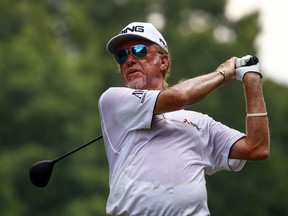 In this May 20, 2018, file photo, Miguel Angel Jimenez tees off during the Regions Tradition PGA Champions Tour golf tournament in Birmingham, Ala. Jimenez and Stephen Ames were sharing the lead on 9-under when darkness ended play early in the second round of the Senior British Open on July 27. Ames is among 18 players who needed to return Saturday to complete their rounds.