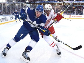 Toronto Maple Leafs centre Frederik Gauthier (33) and Detroit Red Wings left wing Drew Miller (20) battle for possession of the puck during first period NHL Centennial Classic hockey action in Toronto on Jan. 1, 2017.