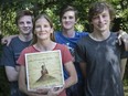 Renee Bombardier is seen with her three sons, from left, Logan, 17, Eric, 15, and Jeremy, 19, at their home in Essex, Sunday July 1,  2018.  The family recently won a $10,000 prize for solving the treasure hunt in the book In Pursuit of the Golden Key.