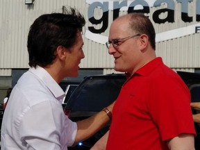 Prime Minister Justin Trudeau (left) talks with Mayor Drew Dilkens at the Greatlakes Flight Centre at the Windsor Airport on Canada Day, July 1, 2018. Dilkens has written a letter to Trudeau on the issue of using U.S. vaccines in Canada.