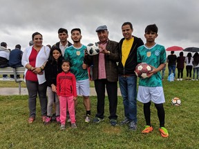 Bibas Pokhrel, Indra Timsina, Ram Sigdel, Bhavuaon Thapa, Bhanu Chamlagai, Tila Sapkota, Beequeen Chamlagai (front left) and Sameena Chamlagai (front right) pose at McHugh Park Soccer Complex in Windsor Saturday, July 21, 2018. The adults helped organize an inter-city soccer tournament for Bhutanese people who once lived as refugees in Nepal, but now live in North America.