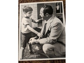 In this 1971 file photo, a young Mark explains to his father, Peter Boscariol, how a group of men broke into their house and used neckties and belts to tie up Mark, his mother and the housekeeper during a robbery. His father was at work at the time, his older sister in school.