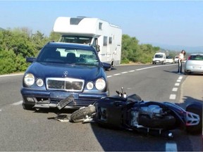 A scooter lies next to a car following an accident near Olbia, on Sardinia island, Italy, on July 10, 2018. Actor George Clooney was taken to hospital in Sardinia on Tuesday and released.