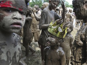 Charles Daviskiba, 3, is seen after being crowned Mud Day King during Mud Day at the Nankin Mills Park on July 10, 2018, in Westland, Mich. The event marked the 31st year Wayne County Parks has hosted the event. While much of the event was children and parents playing in the mud, park officials organized various races and a limbo line.