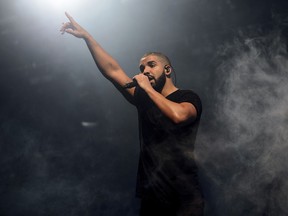FILE - In this June 27, 2015 file photo, Canadian singer Drake performs on the main stage at Wireless festival in Finsbury Park, London. All 25 tracks from Drake's ultra-popular "Scorpion" album, released on June 29, are on the Billboard Hot 100 chart.